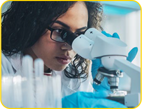 woman looks into a microscope