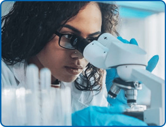 woman looks into a microscope